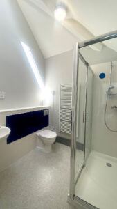 A bathroom featuring separate shower, toilet and sink.