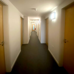 A view of a hallway in The Hollies, with multiple doors branching off from a central corridor.